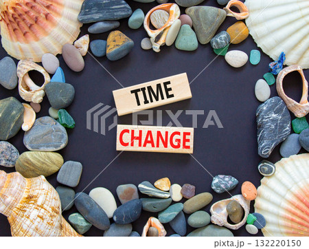 Time change symbol. Concept word Time change on beautiful wooden blocks. Beautiful black paper background. Beautiful sea stones and sea shells. Business time change concept. Copy space. 132220150