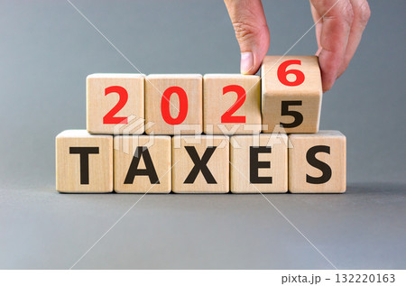 2026 taxes new year symbol. Concept words 2026 taxes on beautiful wooden blocks. Beautiful grey paper background. Businessman's hand. Business and 2026 taxes new year concept. Copy space. 2026 taxes new year symbol. Concept words 2026 taxes on beautiful wooden blocks. Beautiful grey paper background. Businessman's hand. Business and 2026 taxes new year concept. Copy space. 132220163