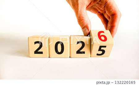 Business concept of 2026 new year symbol. Businessman turns wooden cube and changes number 2025 to 2026. Beautiful white table white background, copy space. Business 2026 happy new year concept. 132220165