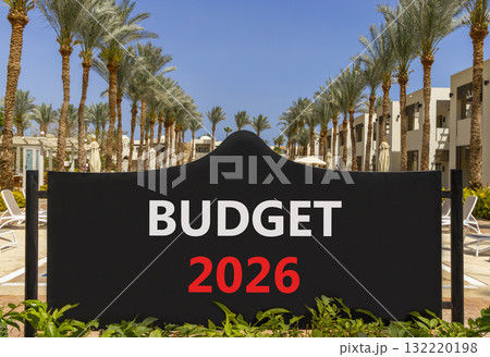 Budget 2026 symbol. Concept words Budget 2026 on beautiful black road sign. Beautiful palm trees palm-trees and blue sky background. Business and budget 2026 concept. Copy space. Budget 2026 symbol. Concept words Budget 2026 on beautiful black road sign. Beautiful palm trees palm-trees and blue sky background. Business and budget 2026 concept. Copy space. 132220198
