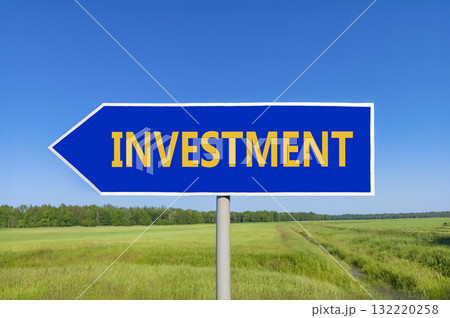 Investment symbol. Concept word Investment on beautiful blue road sign. Beautiful blue sky green grass and forest peaceful nature background. Business investment concept. Copy space. Investment symbol. Concept word Investment on beautiful blue road sign. Beautiful blue sky green grass and forest peaceful nature background. Business investment concept. Copy space. 132220258