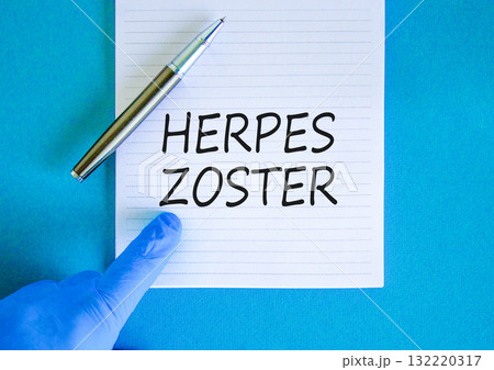 Herpes zoster symbol. Concept words Herpes zoster on beautiful white note. Doctor's hand in blue medical glove. Black pen. Beautiful blue background. Medical healthy lifestyle herpes zoster concept Herpes zoster symbol. Concept words Herpes zoster on beautiful white note. Doctor's hand in blue medical glove. Black pen. Beautiful blue background. Medical healthy lifestyle herpes zoster concept 132220317