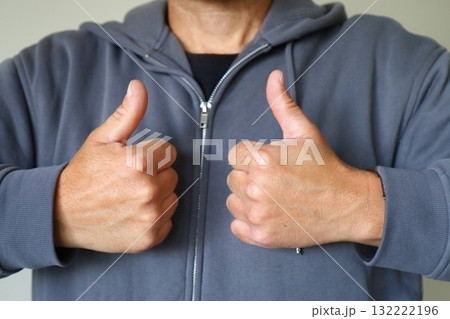 Man showing double thumbs up gesture 132222196