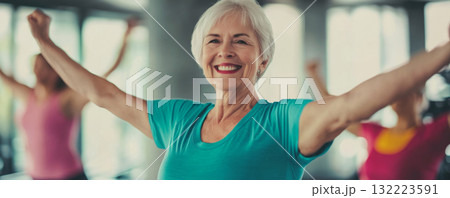 Senior Woman Enjoying Group Exercise Class in Gym Senior Woman Enjoying Group Exercise Class in Gym 132223591