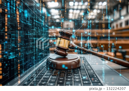 A wooden gavel sits on top of a laptop computer A wooden gavel sits on top of a laptop computer 132224207