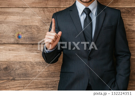 Businessman in Suit Pointing at Bar Graph for Success and Growth Strategies in the Office Businessman in Suit Pointing at Bar Graph for Success and Growth Strategies in the Office 132224351