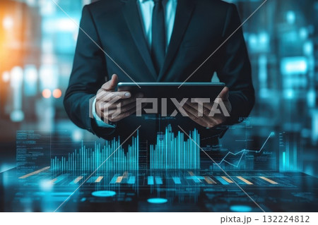 A man in a suit is holding a tablet in front of a screen with a lot of numbers 132224812