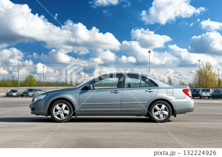 Professional Parked Car in Spacious Outdoor Parking Lot Under a Clear Sky with Vibrant Clouds 132224926