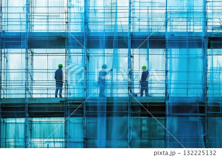 Construction Workers on Scaffolding Surrounded by Blue Mesh Netting at Building Site in Urban Environment During Daylight Construction Workers on Scaffolding Surrounded by Blue Mesh Netting at Building Site in Urban Environment During Daylight 132225132