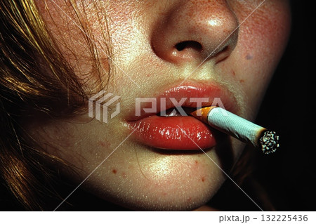 Close-Up of Female Lips Holding a Cigarette, Highlighting Glossy Finish and Freckles, Capturing the Intensity and Complexity of Youthful Rebellion and Contemporary Culture 132225436