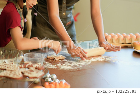 Baking Memories Parent and Child Rolling Dough Together 132225593