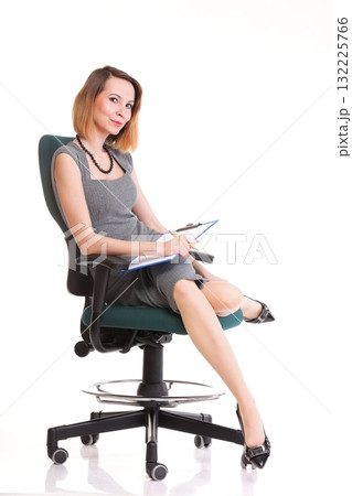 young business woman sitting with her clipboard isolated young business woman sitting with her clipboard isolated 132225766