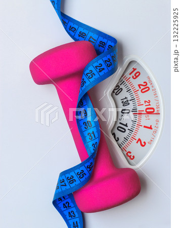 Dumbbell measuring tape on weight scale. Fitness 132225925
