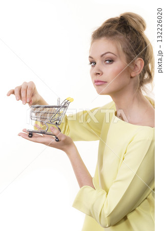 Woman holding small shopping cart Woman holding small shopping cart 132226020