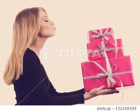 Girl holding stack of pink gift boxes 132226593
