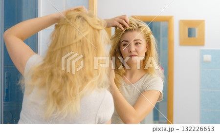 Female having problem with blonde hair 132226653