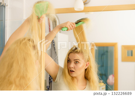 Sad woman brushing hair 132226689