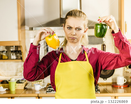 Woman holding bell peppers paprika thinking Woman holding bell peppers paprika thinking 132226869