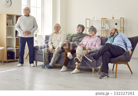 Group of happy senior people watching television at home or in retirement community Group of happy senior people watching television at home or in retirement community 132227201