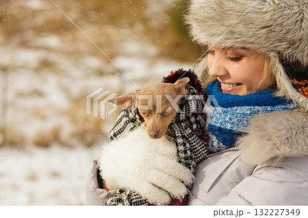 Woman hug warming her little dog in winter 132227349