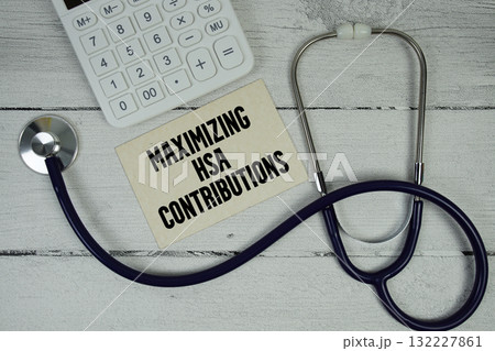 Maximizing HSA Contributions text with Stethoscope and calculator on wooden background Maximizing HSA Contributions text with Stethoscope and calculator on wooden background 132227861