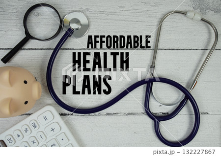 Affordable Health Plans text with Stethoscope and magnifying glass on wooden background 132227867