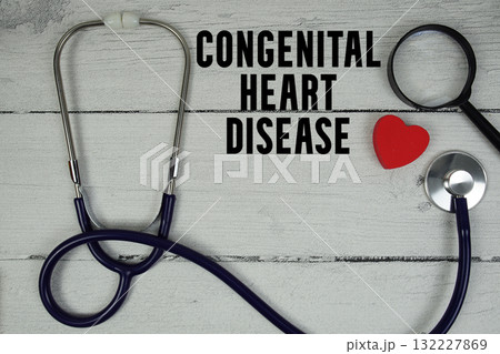 Congenital Heart Disease text with Red heart, Magnifying glass and Medical Stethoscope on wooden background 132227869