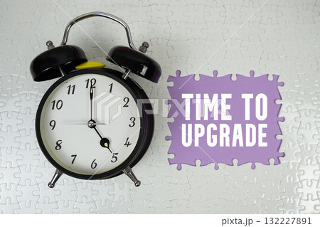 Time To Upgrade text with alarm clock on purple background 132227891