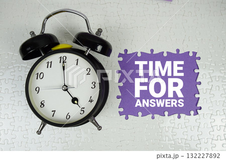 Time For Answers text with alarm clock on purple background Time For Answers text with alarm clock on purple background 132227892