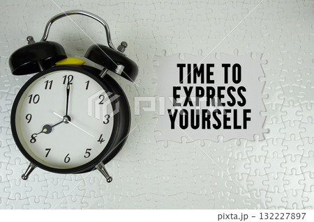 Time To Express Yourself text with alarm clock on white background Time To Express Yourself text with alarm clock on white background 132227897
