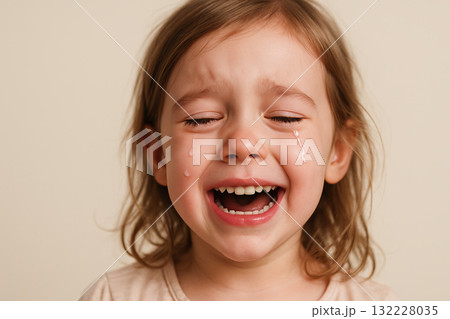 Tears of joy of a child expressing pure emotion with open mouth and eyes filled with happiness and tears. concept of childhood innocence, emotional release, joyful tears 132228035