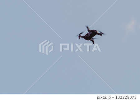 Drone flying over sky background 132228075