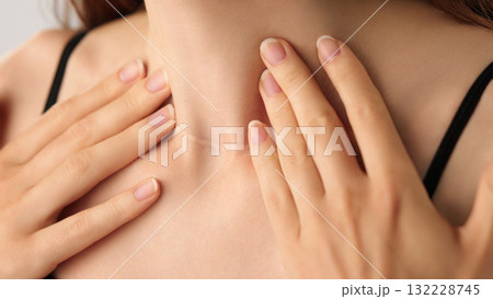 Close-up of an unrecognizable woman touching her neck. Endocrine health prevention, treatment. Diseases of the thyroid gland. Cancer screening. Endocrinology. Medical concept, Healthcare, Self-care. 132228745