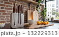A chic set of mocha mousse kitchen knives with smooth wooden handles and matte-finished blades, displayed on a magnetic knife 132229313