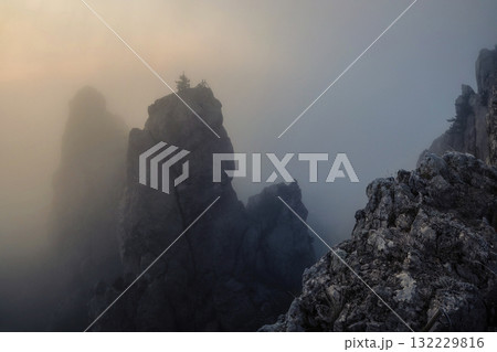 Morning fog and mountains, as the sun rises above 132229816