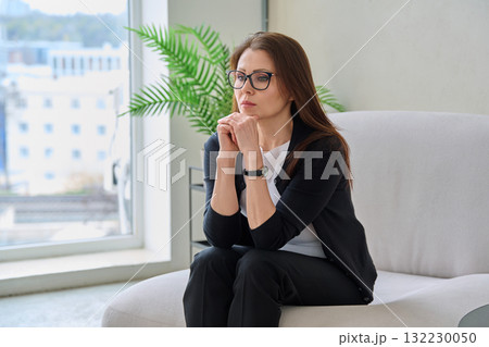 Mature sad woman experiencing stress, mental and physical pain, at home 132230050