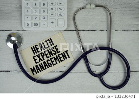 Health Expense Management text with Stethoscope and calculator on wooden background 132230471