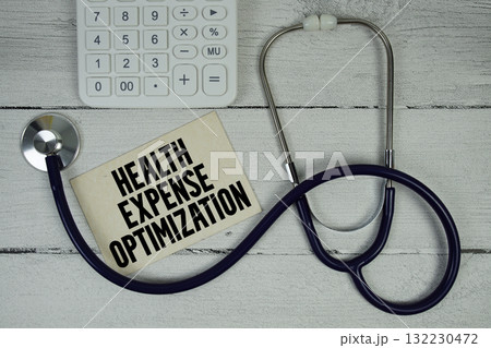 Health Expense Optimization text with Stethoscope and calculator on wooden background 132230472