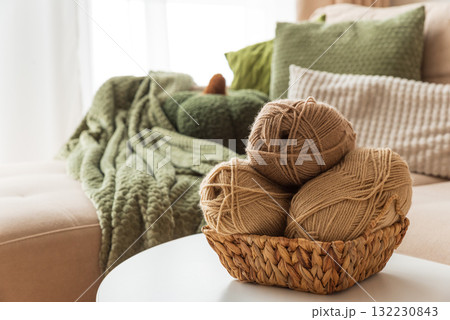 Basket with Yarn Balls on White Table in Cozy Living Room Basket with Yarn Balls on White Table in Cozy Living Room 132230843