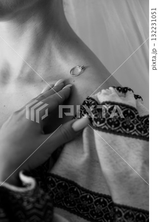 Intimate Close-up of a Woman Holding a Diamond Ring, Black and White, Lace Detail, Sensual Gesture, Jewelry, Romance, Luxury, Soft Focus Portrait. Intimate Close-up of a Woman Holding a Diamond Ring, Black and White, Lace Detail, Sensual Gesture, Jewelry, Romance, Luxury, Soft Focus Portrait. 132231051