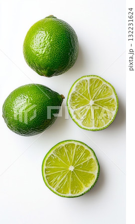 Fresh Limes and Lime Slices Arranged With Green Leaves on a White Background Fresh Limes and Lime Slices Arranged With Green Leaves on a White Background 132231624