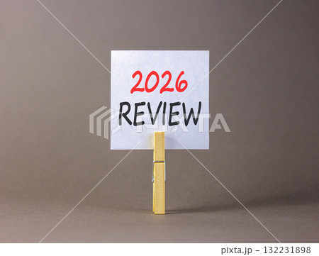 2026 Review symbol. Concept words 2026 Review on beautiful white paper on wooden clothespin. Beautiful grey background. Business and 2026 review concept. Copy space. 2026 Review symbol. Concept words 2026 Review on beautiful white paper on wooden clothespin. Beautiful grey background. Business and 2026 review concept. Copy space. 132231898