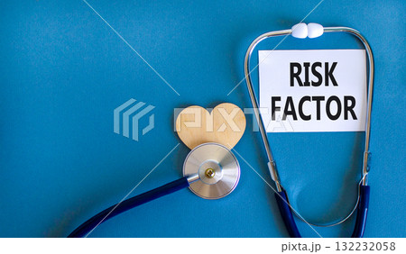 Risk factor symbol. Concept words Risk factor on beautiful white card. Wooden heart and stethoscope. Beautiful blue background. Medical healthy lifestyle risk factor concept. Risk factor symbol. Concept words Risk factor on beautiful white card. Wooden heart and stethoscope. Beautiful blue background. Medical healthy lifestyle risk factor concept. 132232058