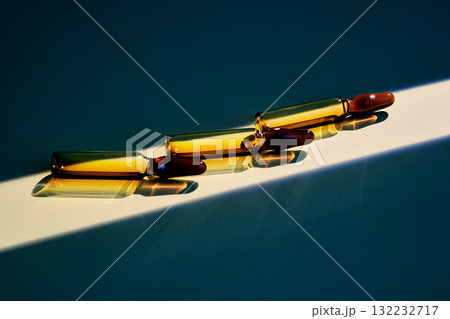 Three ampoules of the medicine in a beam of bright light. Three ampoules of the medicine in a beam of bright light. 132232717