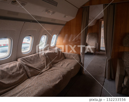 private cabin suite with doorway revealing cozy seating area and curtain divider, polished wood surfaces and ambient light emphasize intimate luxury and secluded travel space for vip 132233556