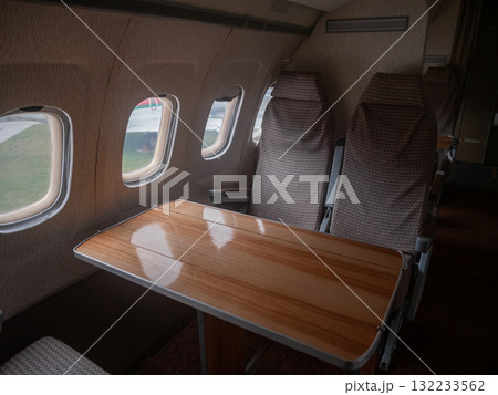 luxury aircraft table, refined polished aircraft table featuring scenic window views and dual seats, luxury dualseat wooden aircraft table with scenic window views and elegant polishing 132233562