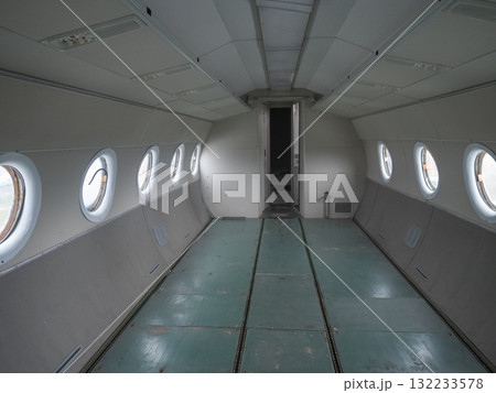open aircraft cabin spaciously designed with cargo space and lighting features, broad airplane interior setting equipped with cargo storage areas and strategic lighting installations 132233578
