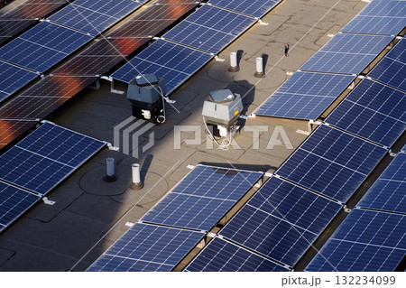 Solar panels on roof of apartment housing building, renewable green sustainable energy concept, water cooling, aerial view Solar panels on roof of apartment housing building, renewable green sustainable energy concept, water cooling, aerial view 132234099