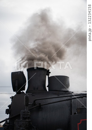 Thick smoke rises from the chimney of a historic black steam locomotive at the Moscow Railway Museum Turntable 132234158