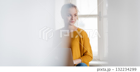 Banner of student during study session, working on laptop. 132234299